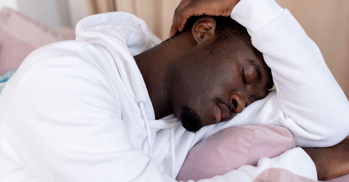 Autistic burnout - A tired black man sleeping