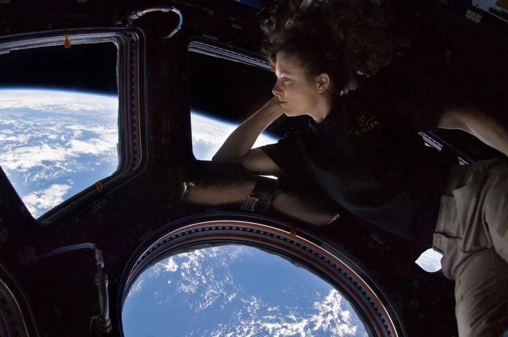 Are there autistic astronauts - A female astronaut in International Space Station gazing at the Earth