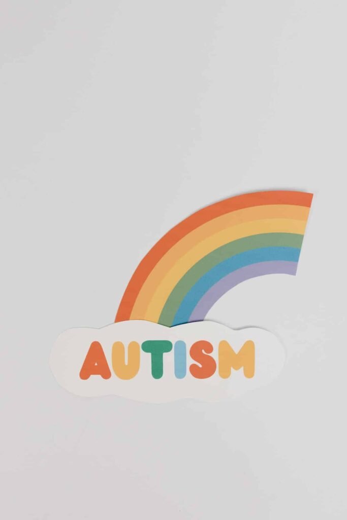 A rainbow and a cloud with the text Autism