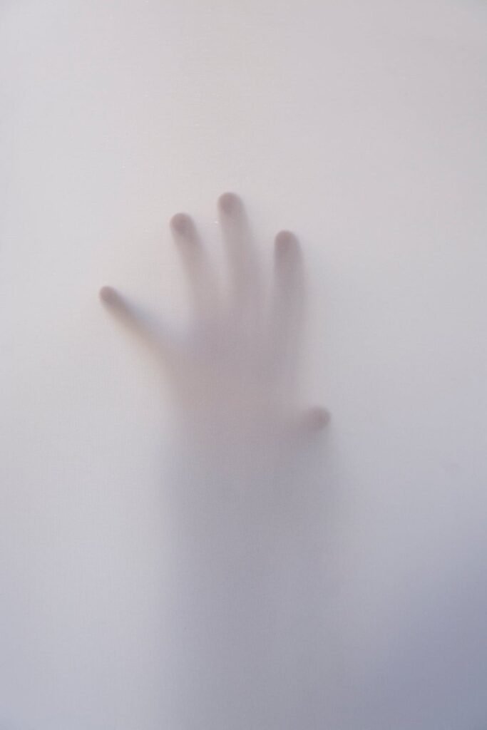 A hand againts the shower door - Horror movie scene