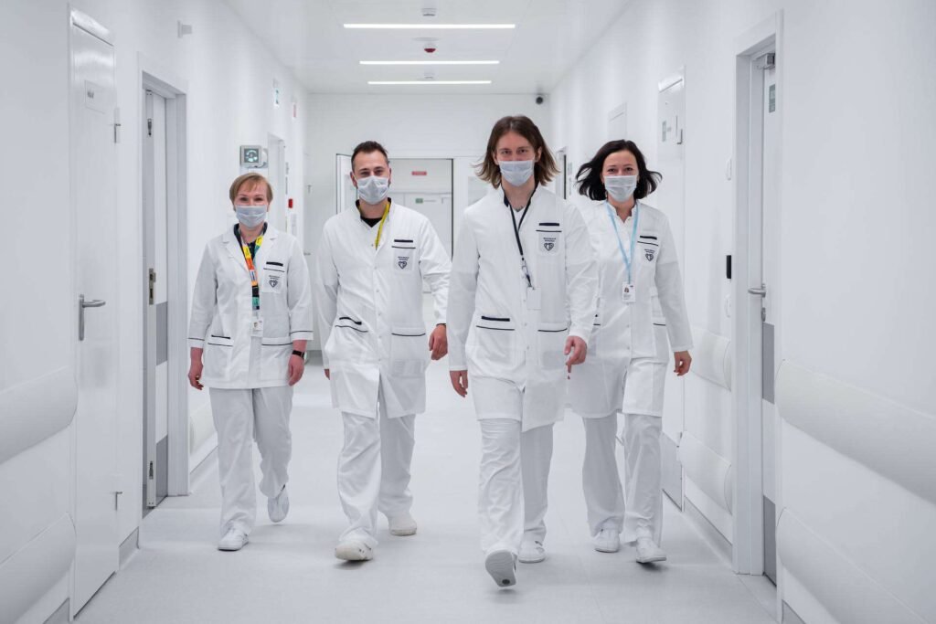 Four doctors walking on a hospital hallway
