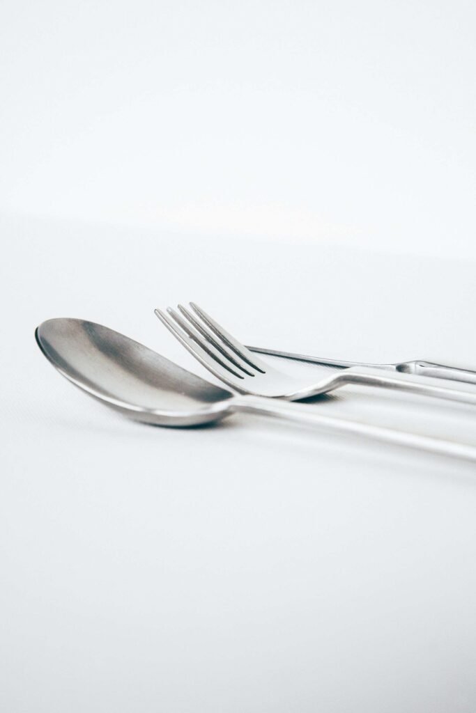 Spoon and fork on white background